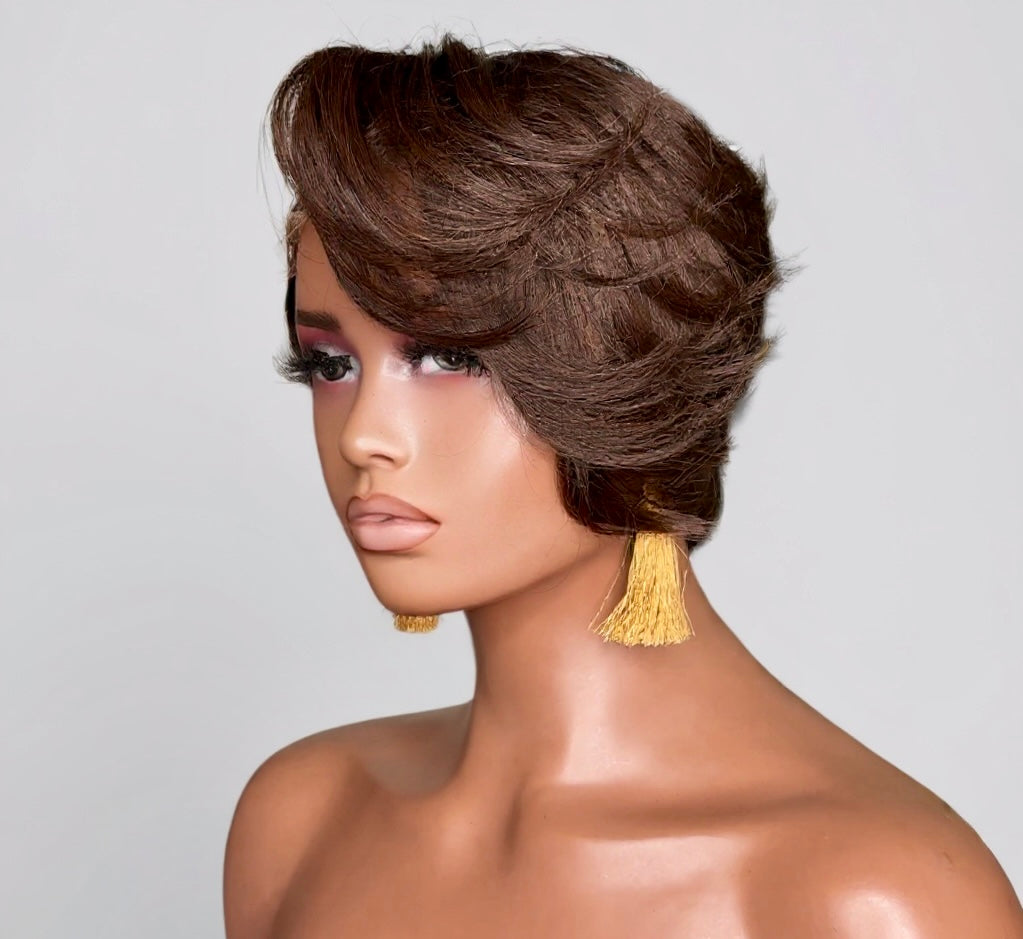 Mannequin head with styled brown hair and gold tassels earrings on a gray background